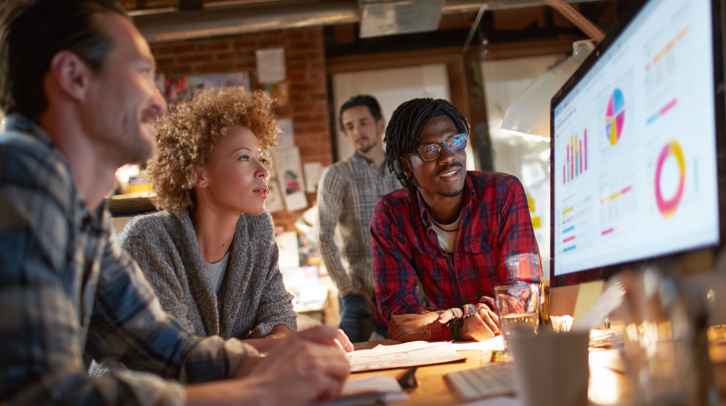 Campaign communications team reviewing polling data and press coverage together in a small campaign office.