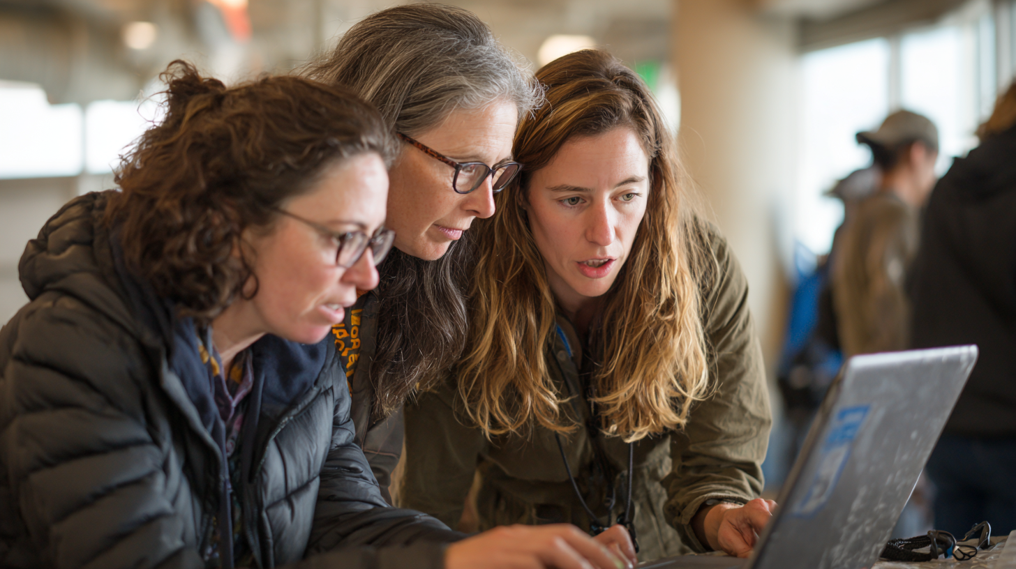 Field organizers reviewing volunteer shift coverage dashboards together on a laptop